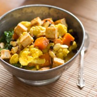 coconut curried sweet potato and cauliflower with sauteed kale, tofu and almonds